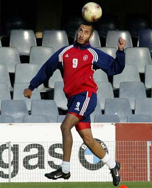 Al-Itthads midfielder Al Saadi Gaddafi, son of Libyan President Muammar Gaddafi, jumps for the ball during a training session at Barcelonas Mini Stadium 