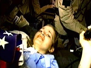 US army soldier Jessica Lynch (19) grimaces inside a US helicopter on Wednesday after being rescued by US special forces.