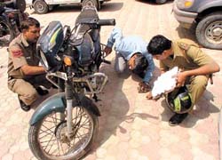 Cops inspecting the motorcycle involved in the encounter. 