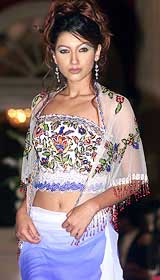A model displays an outfit by fashion designer Suneet Verma