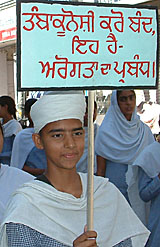 A girl student holds a placard