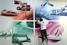 A worker cleans a large poster
