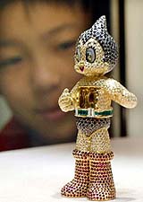 A Japanese boy looks at a 10-cm model of Japan's rocket-powered Astro Boy