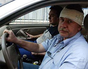 A Russian diplomat wounded in Iraq and his colleague arrive at the Russian Embassy