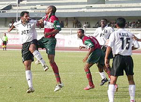 JCT Phagwaras Joe Paul Ancheri is being challenged by Mohun Bagan defender Yakubu as Hardip Gill looks on 