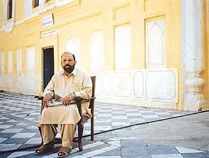 Violation of maryada: A caretaker is seen with shoes and with his head uncovered in the parikarma of Gurdwara Diwan Khana in Lahore