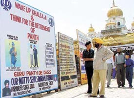A huge poster under the aegis of Guru Panth De Dass outside the historic Gurdwara Bangla Sahib urges the devotees to wake up and work for the bettermen