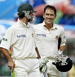 Australian batsmen Justin Langer and Ricky Ponting walk off the pitch following their win over the West Indies