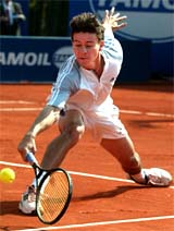 Guillermo Coria of Argentina returns the ball to James Black of America 