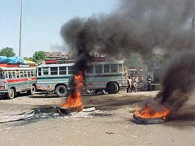 Agitated drivers and cleaners of passenger buses at Jammu bus stand protest against the manhandling of some of their colleagues
