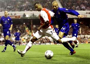 Arsenal's Ashley Cole gets past Manchester United's Wes Brown