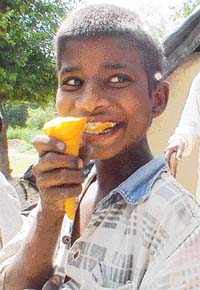 A young boy enjoys an ice-cream