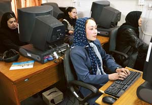 Nabila Akbari (front) and other young Afghani girls sit before computer terminals at Kabul University, in the capital of Afghanistan