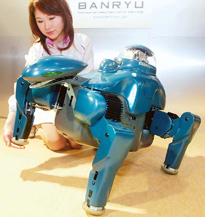 A four-legged walking robot, Banryu, meaning house-sitting dinosaur, offers its paw on command at a press preview in Yokohama. 