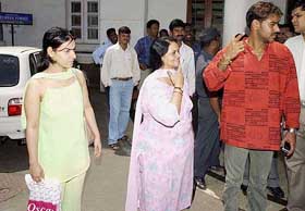 Actor Ajay Devgan with his mother and sister emerging out of Breach Candy Hospital