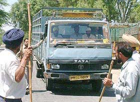 Striking truck operators stop a mini truck