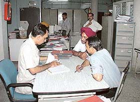 A senior official of Punjab National Bank inspects documents at the banks Sector 22 branch