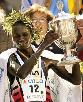 Kenyan Robert Kipkoech Cheriuyot hoists his trophy after winning the men's division of the 2003 Boston Marathon