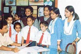 Ajit Narayan, freelance cartoonist from New Delhi, at a workshop of students from BCM Arya Model Senior Secondary School