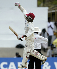 West Indies Brian Lara celebrates after scoring his first century on his home ground 