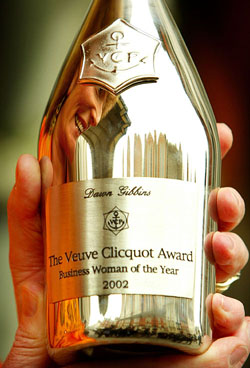 Dawn Gibbins is reflected in a silver bottle of Champagne