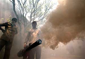 A municipal health worker fumigates a church