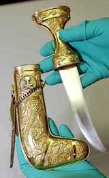 A Bureau of Customs and Border Protection agent holds a knife