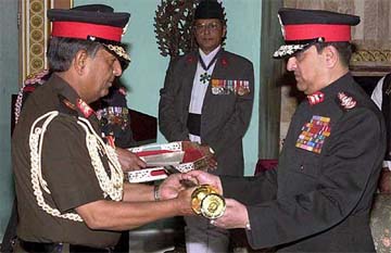 Indian Army Chief General Nirmal Chander Vij, left, receives an honorary sword of generalship
