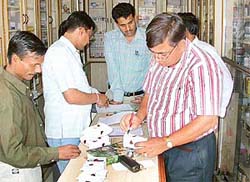 A team of the State Drug Control Department seals samples at a chemists shop