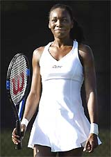 Venus Williams smiles while training for the Fed Cup competition on a private court at her home in West Palm Beach