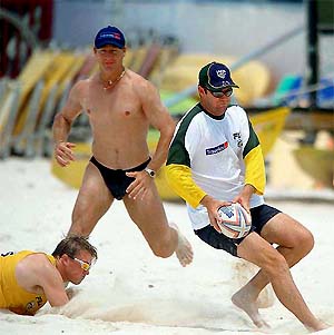 Members of the Australian cricket team, Martin Love, Andy Bichel and Brad Williams, play rugby during a practice session 
