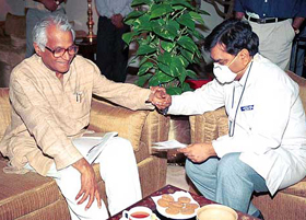 A doctor examines Defence Minister George Fernandes