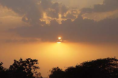 The horizon turns orange as the sun sets in Ambala