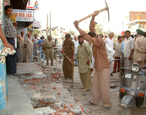 Municipal employees demolish an encroached structure