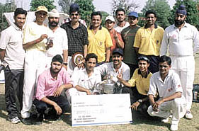 The FCI team, who annexed the Om Nath Sood Cricket Tournament title, with the trophy