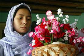 Zamila Zakirhussain, 15, daughter of an Afghan war widow, learns the art of arranging flowers at the CARE training centre in Kabul