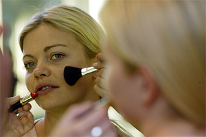 Former model and stylist Jemma Kidd has her face made-up by a student