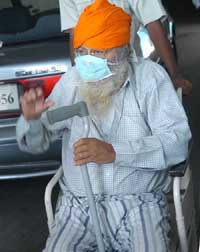SARS suspect Partap Singh being taken for x-rays on a wheelchair at a hospital in Amritsar on Thursday.