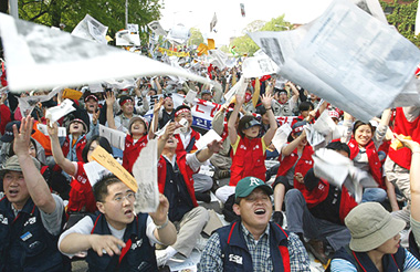 South Korean workers toss leaflets during a May Day rally in Seoul on Thursday. 