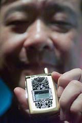 Michael Mou, chairman of Taiwan mobile phone maker DBTEL, displays the world's most expensive cellphone