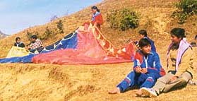 Paragliders prepare for take-off atop Kandara hill in the Paidulsyun valley