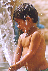 A child plays with water as mercury soars in Bathinda