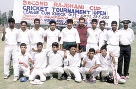The AIIMS team which won the Rajdhani Cup Cricket Tournament flash victory signs