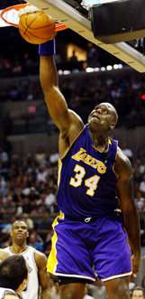 Los Angeles Laker's Shaquille O'Neal slam the ball into the net 