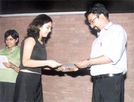 A student from the Indian Institute of Planning and Management getting a certificate