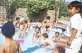 Students of Tender Heart School splash about in a pool during a picnic at Mullanpur, near Chandigarh, on Tuesday.