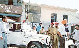 A team of the Vigilance Bureau helped by local police personnel camping in front of the house of Mann Singh Garcha in the Dholewal complex on Friday