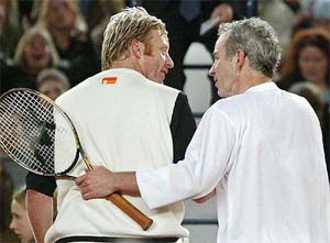 Former tennis superstars, John McEnroe of the US congratulates Boris Becker of Germany