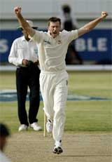 Australia's Glenn McGrath celebrates after he bowled West Indies' Chris Gayle for a duck during play