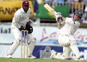 Australias Justin Langer of Australia hits a six off Omari Banks